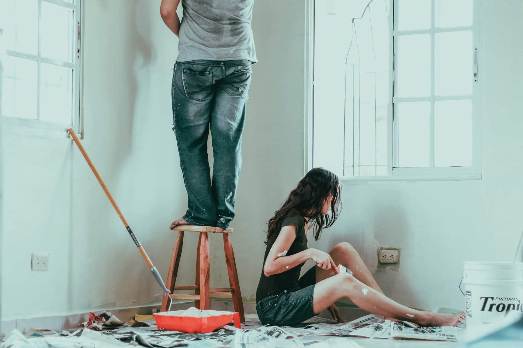 Couple repainting a room together during a home refresh