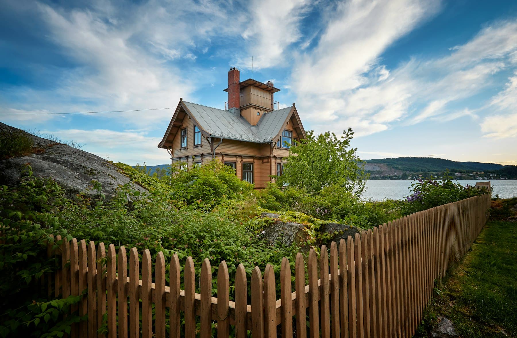 Wooden picket fence surrounding a home garden
